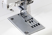 Janome CoverPro 3000P professional cover hem machine front view showing the extra long bed and thread cones.
