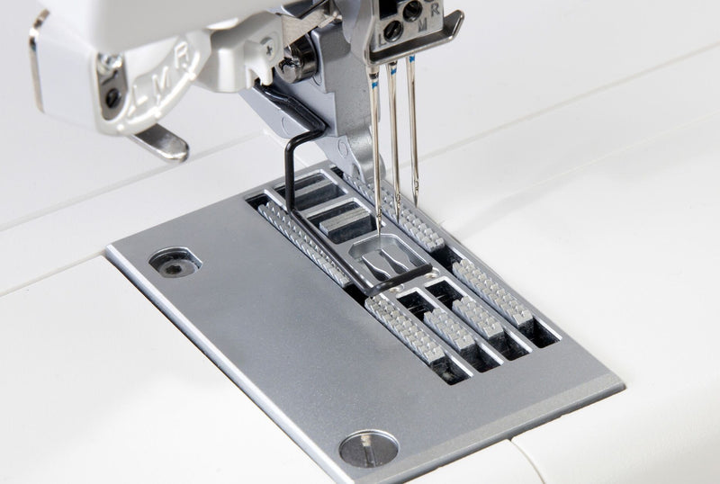 Janome CoverPro 3000P professional cover hem machine front view showing the extra long bed and thread cones.