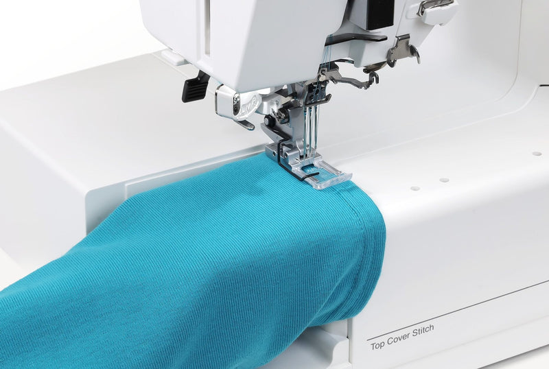 Janome CoverPro 3000P professional cover hem machine front view showing the extra long bed and thread cones.