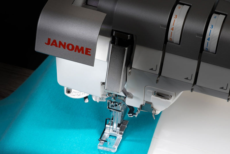 Janome CoverPro 3000P professional cover hem machine front view showing the extra long bed and thread cones.