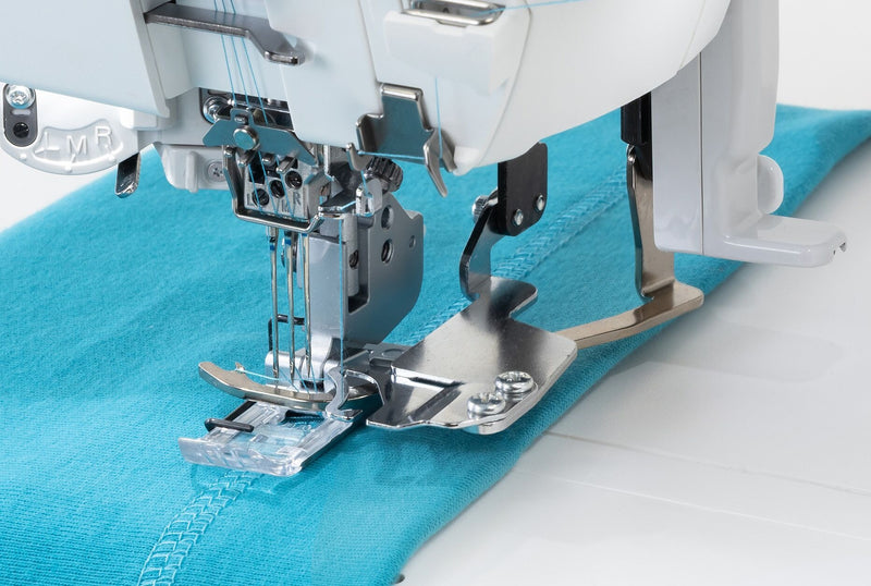 Janome CoverPro 3000P professional cover hem machine front view showing the extra long bed and thread cones.