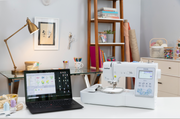 brother-innov-is-ns1850d-combo-sewing-embroidery-machine-with-black-laptop-on-white-craft-desk