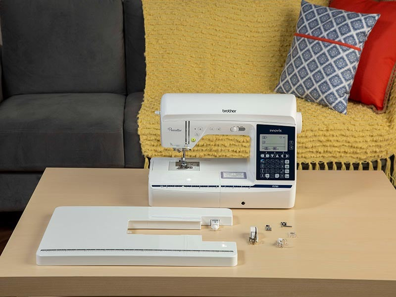 brother-pacesetter-innov-is-ps700-sewing-machine-on-wooden-desk-with-detached-extension-table-and-presser-feet
