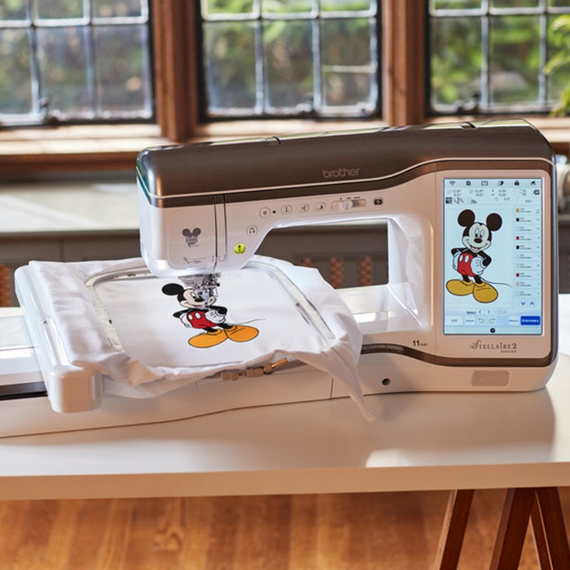 A close-up of a finished Disney character embroidery design on fabric next to the Brother Stellaire XJ2 sewing arm