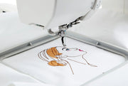Janome Memory Craft 100E computerized embroidery machine front view showing color touchscreen.