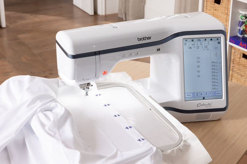 overhead-angle-brother-celeste-innov-is-cx1e-embroidery-machine-stitching-blue-floral-patterns-on-white-fabric