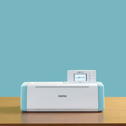 brother-scancut-dx-sdx85s-cutting-machine-closed-front-view-sitting-on-wooden-table-with-light-blue-background