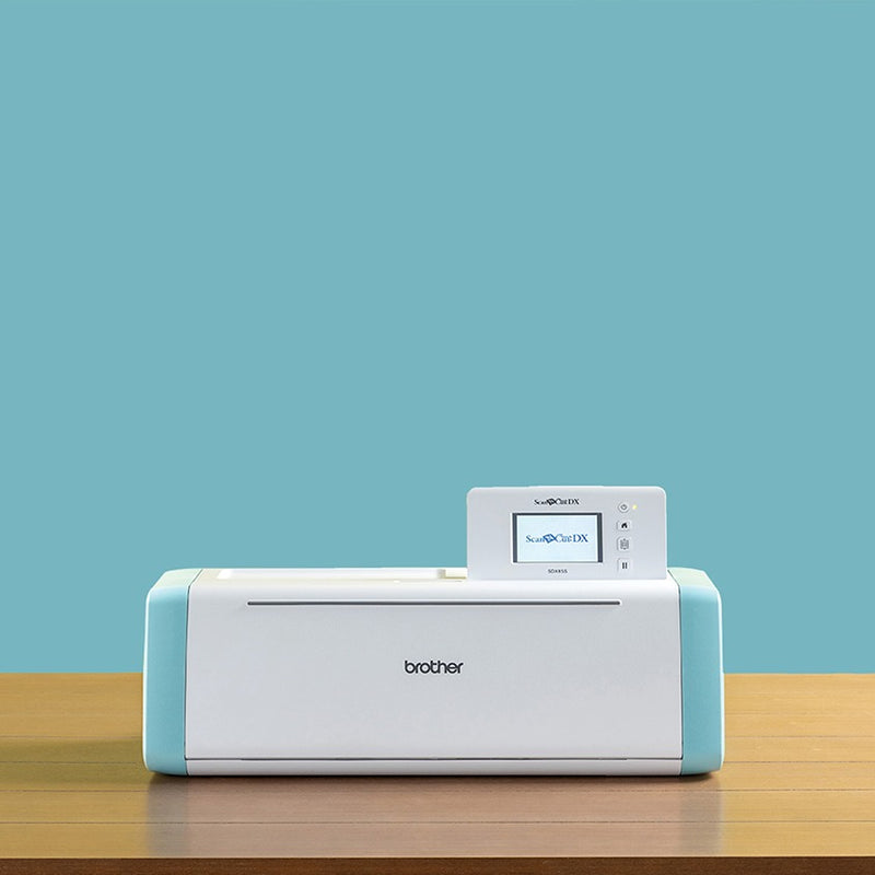 brother-scancut-dx-sdx85s-cutting-machine-closed-front-view-sitting-on-wooden-table-with-light-blue-background