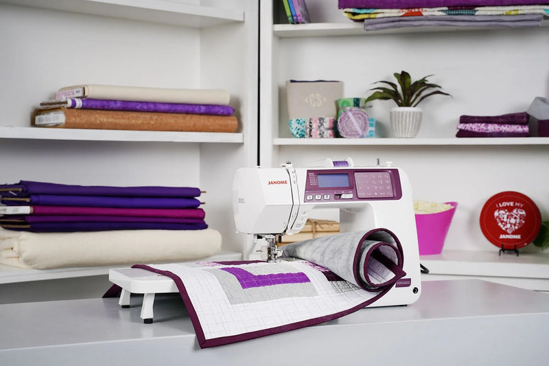 Janome 5300QDC-G computerized sewing and quilting machine in grapevine purple front view.
