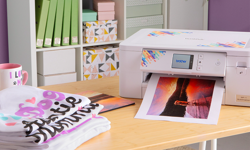 brother-sp-1-sublimation-printer-outputting-vibrant-sunset-photo-on-wooden-table-next-to-printed-t-shirts