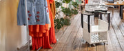 brother-prnstd2-machine-stand-holding-multi-needle-embroidery-machine-in-apparel-studio-view