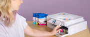 woman-inserting-sublimation-ink-cartridge-into-maintenance-bay-of-brother-sp-1-sublimation-printer