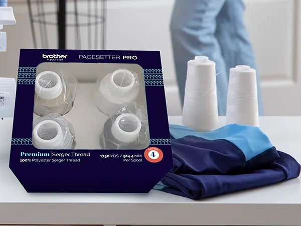 brother-pacesetter-pro-premium-serger-thread-four-spools-pack-on-table-with-folded-fabric