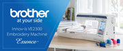 brother-innov-is-ve2300-essence-embroidery-machine-on-wooden-craft-table-blue-promo-banner-view