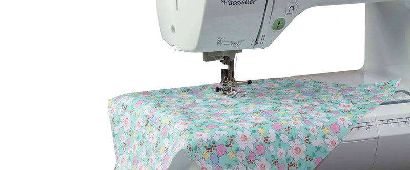 close-up-needle-stitching-floral-patterned-fabric-on-brother-pacesetter-innov-is-ps500-sewing-machine