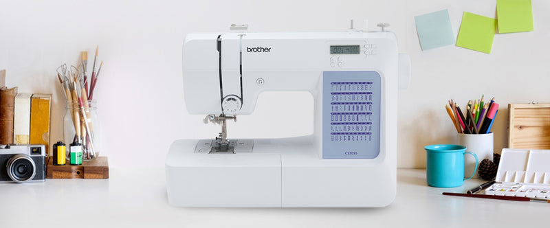 brother-cs5055-computerized-sewing-machine-lifestyle-view-on-white-craft-desk-with-art-supplies