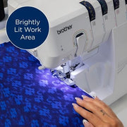 brother-air1800-air-serger-front-view-on-white-table-with-foot-pedal-and-included-accessories