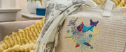 close-up-detailed-floral-and-butterfly-embroidery-pattern-stitched-onto-woven-canvas-tote-bag