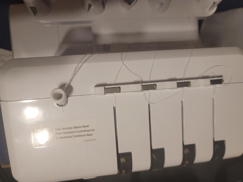 overhead-close-up-pre-threaded-channels-and-tension-dials-on-top-casing-of-brother-airflow-3000-air-serger
