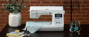 brother-pacesetter-innov-is-ps500-sewing-machine-on-dark-table-with-floral-fabric-and-notions