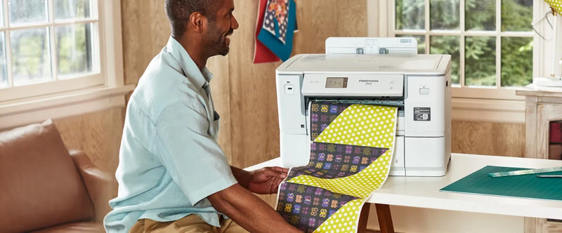 man-watching-patterned-lime-green-fabric-roll-output-from-brother-printmoda-studio-fabric-printer-hl-jf1