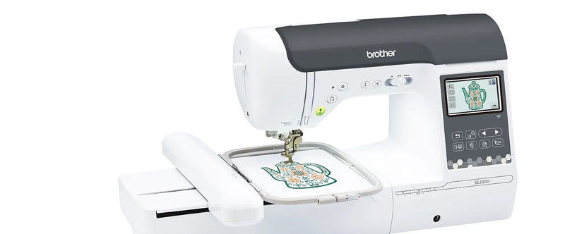 close-up-embroidery-hoop-stitching-teapot-design-on-white-fabric-with-brother-se2000-machine