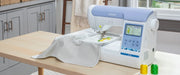 brother-pe900-embroidery-machine-on-wooden-table-stitching-lemon-pattern-next-to-thread-spools