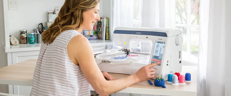 side-angle-view-woman-operating-brother-innov-is-ve2300-essence-embroidery-machine-at-home-workstation