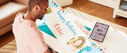man-holding-long-custom-printed-happy-birthday-banner-next-to-tablet-and-brother-printmoda-studio-fabric-printer-hl-jf1