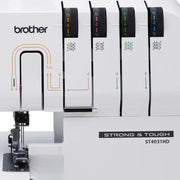 brother-strong-and-tough-st4031hd-serger-close-up-view-of-four-thread-tension-dials-and-threading-guides