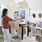 brother-entrepreneur-w-pr680w-6-needle-embroidery-machine-lifestyle-view-with-woman-operating-touchscreen