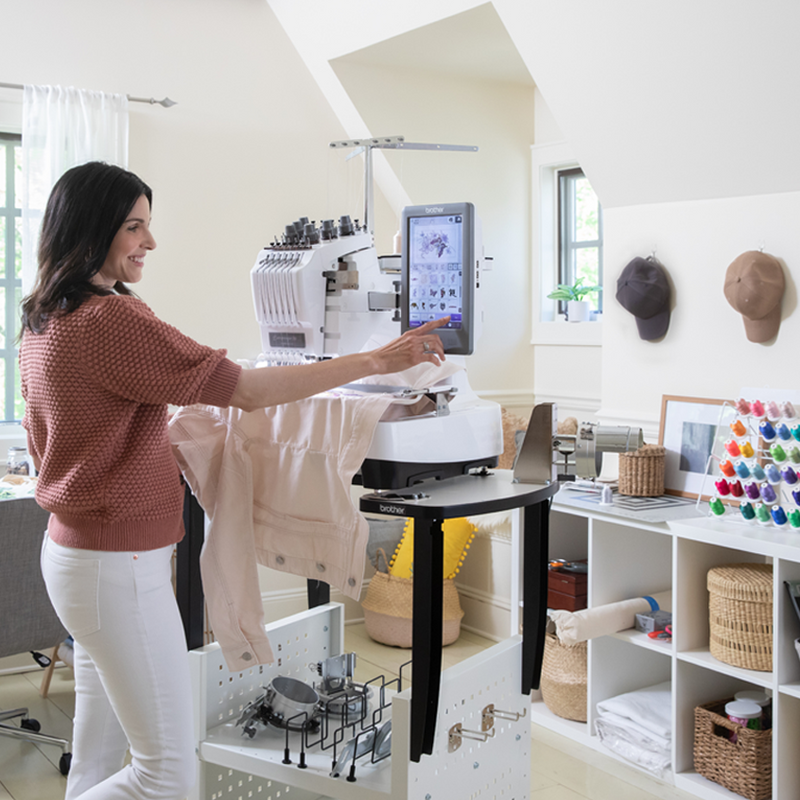 brother-entrepreneur-w-pr680w-6-needle-embroidery-machine-lifestyle-view-with-woman-operating-touchscreen