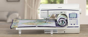 brother-innov-is-bq1350-sewing-machine-stitching-patterned-quilt-on-white-extension-table-front-view