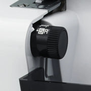 brother-strong-and-tough-st4031hd-serger-close-up-view-of-stitch-width-adjustment-dial-above-trim-trap