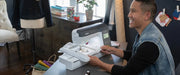 lifestyle-view-of-man-smiling-while-operating-brother-innov-is-ns2850d-combo-sewing-embroidery-machine