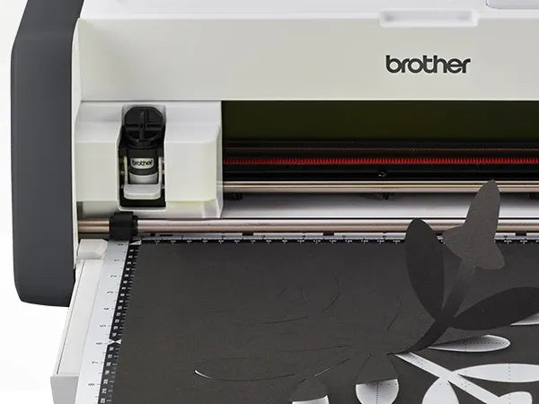 brother-scancut-dx-sdx85c-cutting-machine-close-up-view-of-standard-tack-adhesive-mat-with-hand-and-green-polka-dot-fabric