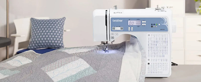 brother-xr9550-sewing-and-quilting-machine-lifestyle-view-quilting-a-grey-and-white-patterned-fabric