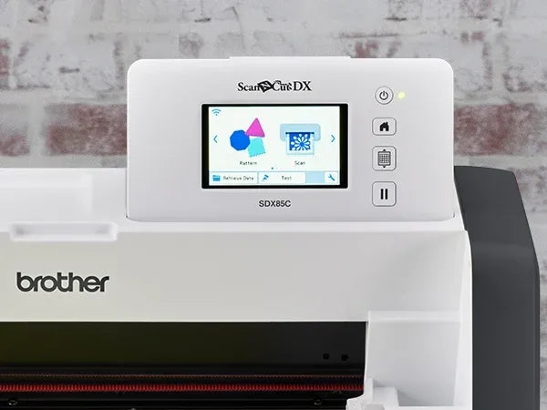 brother-scancut-dx-sdx85c-cutting-machine-close-up-view-of-hand-holding-auto-blade-holder-next-to-purple-standard-tack-mat