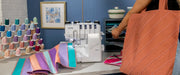 brother-air1800-air-serger-close-up-view-of-needle-area-showing-brightly-lit-work-area-with-blue-patterned-fabric