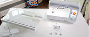 brother-innov-is-bq2500-sewing-machine-on-white-table-with-unboxed-quilters-bundle-accessories-kit-spread