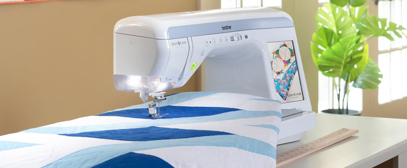 brother-innov-is-bq2500-sewing-machine-stitching-blue-and-white-geometric-quilt-top-front-angle-view