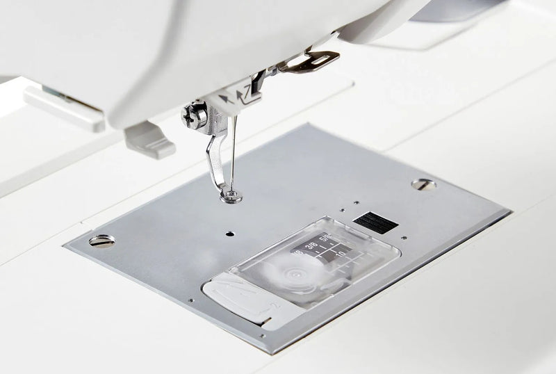 Janome Memory Craft 100E computerized embroidery machine front view showing color touchscreen.