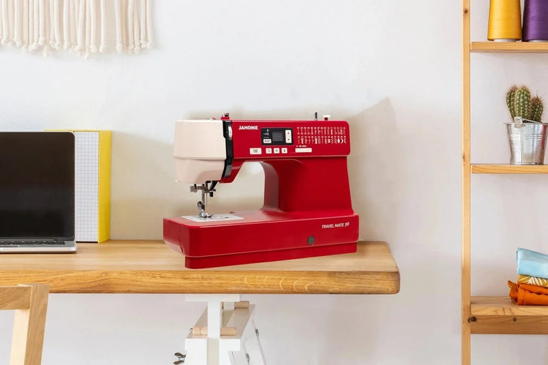 Janome TravelMate 30 computerized portable sewing machine front view showcasing stitch options and control sliders.