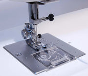 Janome 712T non-electric treadle sewing machine front view showcasing the oversized handwheel and flatbed design.