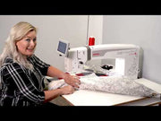 Janome Quilt Maker Pro 20 Versa ST sit-down longarm set into the electronic lift table.
