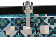 Janome Quilt Maker 15 compact longarm quilting machine head highlighting the LCD monitor and ergonomic handlebars.