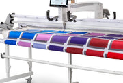 Janome Quilt Maker Pro 20 longarm quilting machine head highlighting the LCD touchscreen and digital tension.