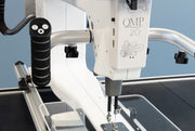 Janome Quilt Maker Pro 20 longarm quilting machine head highlighting the LCD touchscreen and digital tension.