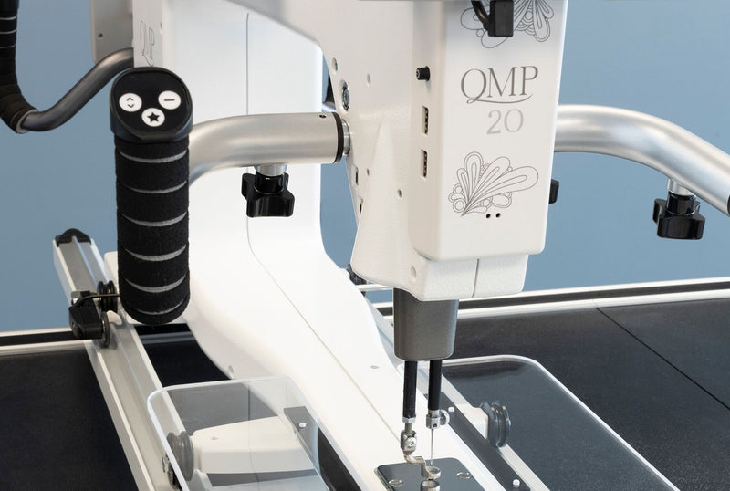 Janome Quilt Maker Pro 20 longarm quilting machine head highlighting the LCD touchscreen and digital tension.
