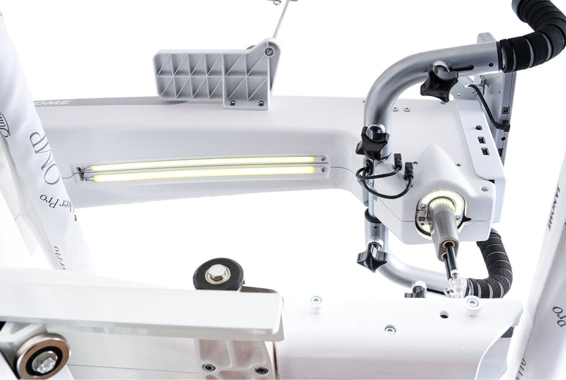 Janome Quilt Maker Pro 20 longarm quilting machine head highlighting the LCD touchscreen and digital tension.